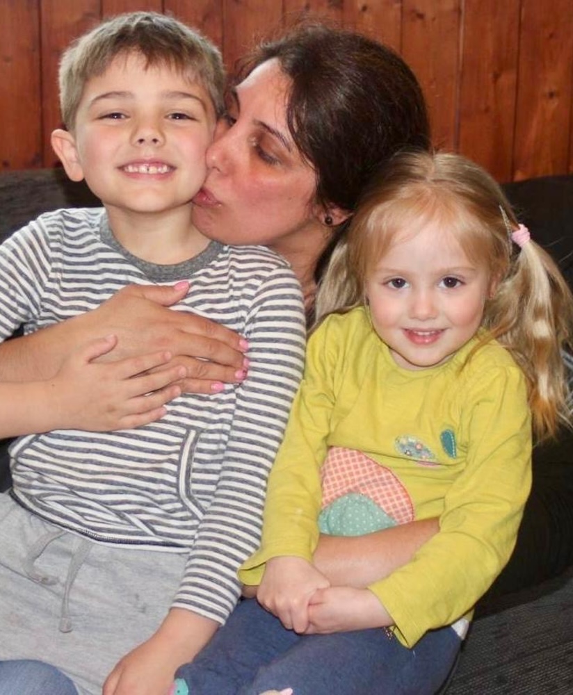 Cartoon image of a mother holding a baby lovingly