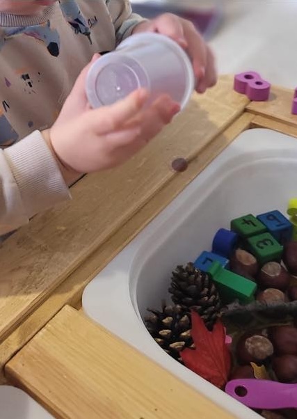 Image of a toddler being creative